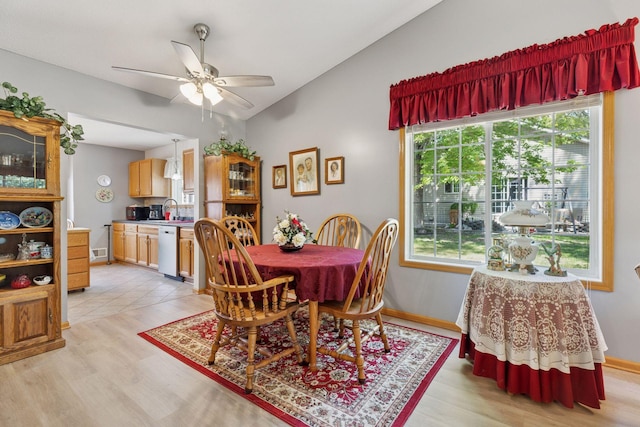 11521 Poppy St NW, Coon Rapids, MN 55433 - dining room with light wood-style flooring, plenty of natural light, vaulted ceiling, and ceiling fan
