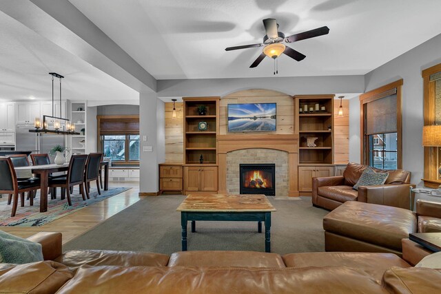912 21st Ave N, Sartell, MN 56377 - living area with carpet flooring, a brick fireplace, and ceiling fan with notable chandelier