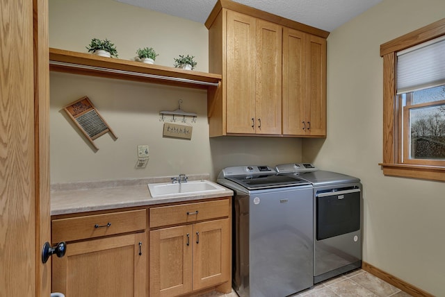 912 21st Ave N, Sartell, MN 56377 - laundry room with washing machine and clothes dryer, cabinet space, a sink, baseboards, and light tile patterned floors
