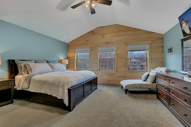 912 21st Ave N, Sartell, MN 56377 - bedroom featuring wooden walls, multiple windows, vaulted ceiling, and light colored carpet