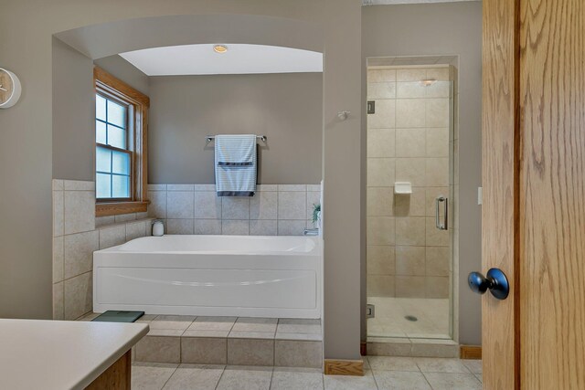 912 21st Ave N, Sartell, MN 56377 - bathroom featuring a garden tub, tile patterned floors, tile walls, and a shower stall