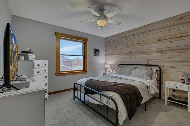 912 21st Ave N, Sartell, MN 56377 - bedroom featuring ceiling fan, wood walls, and light colored carpet
