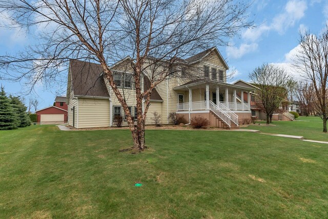 912 21st Ave N, Sartell, MN 56377 - view of front of home featuring an outdoor structure, a front lawn, a detached garage, stairway, and covered porch
