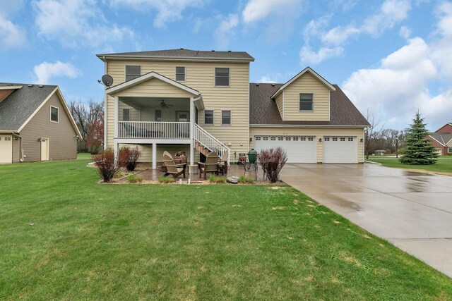 912 21st Ave N, Sartell, MN 56377 - back of house featuring a garage, ceiling fan, concrete driveway, a lawn, and stairway