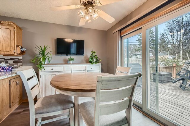 dining area featuring a ceiling fan and wood finished floors
