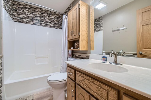 bathroom with vanity, toilet, and shower / tub combo with curtain