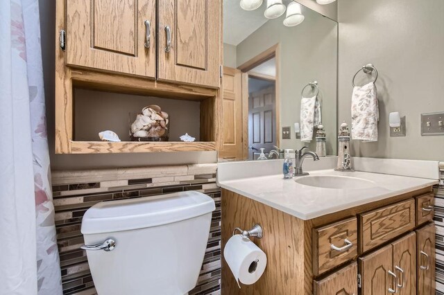 bathroom with toilet and vanity
