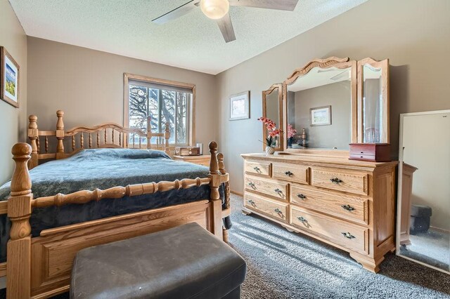 carpeted bedroom with a ceiling fan and a textured ceiling