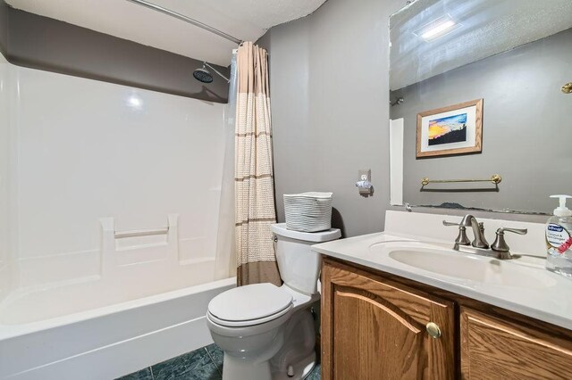 bathroom featuring shower / bath combo with shower curtain, toilet, and vanity