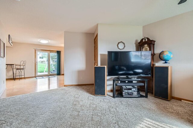living room with carpet floors and baseboards