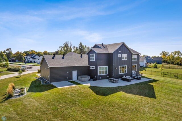 rear view of property with a patio area, fence, an outdoor hangout area, a yard, and a shingled roof