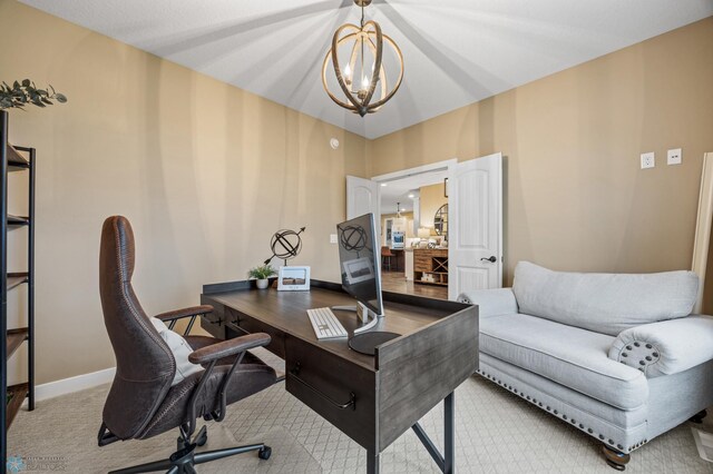 home office with light colored carpet, baseboards, and a notable chandelier
