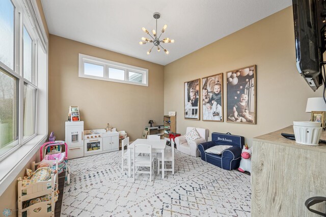 game room with carpet floors and an inviting chandelier