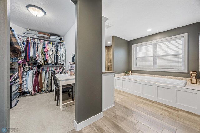 walk in closet with light wood-style flooring