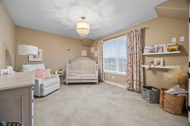 carpeted bedroom with baseboards, a textured ceiling, and lofted ceiling