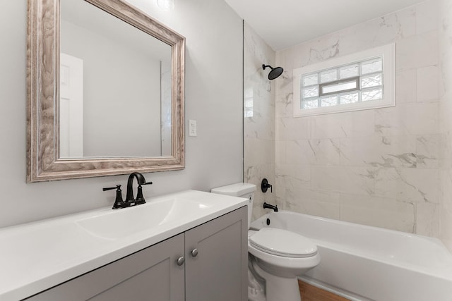 bathroom featuring vanity, bathtub / shower combination, and toilet