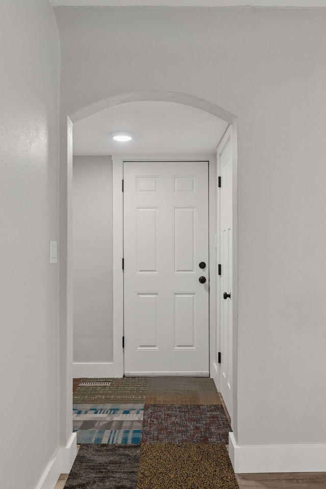 2979 Centerville Rd, Little Canada, MN 55117 - doorway to outside featuring baseboards and arched walkways
