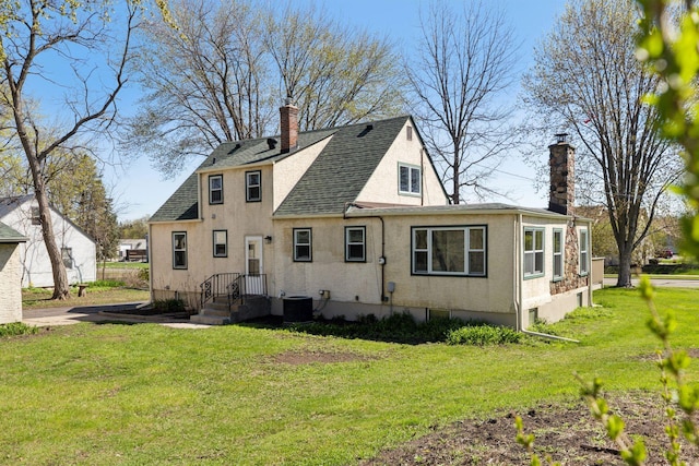 2979 Centerville Rd, Little Canada, MN 55117 - back of property with a shingled roof, a chimney, a yard, and stucco siding
