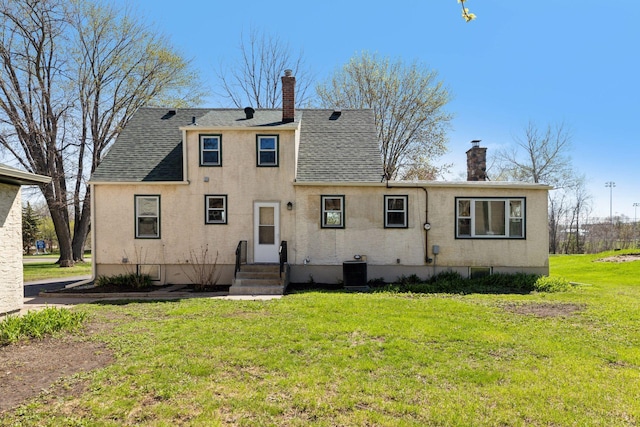 2979 Centerville Rd, Little Canada, MN 55117 - back of property with a yard, cooling unit, a chimney, and a shingled roof