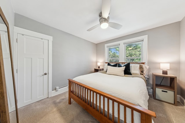 carpeted bedroom featuring baseboards and a ceiling fan
