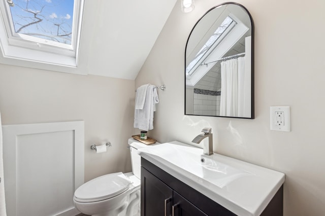full bathroom with vaulted ceiling, vanity, and toilet