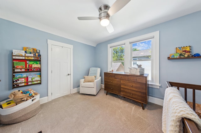 carpeted bedroom featuring baseboards and a ceiling fan