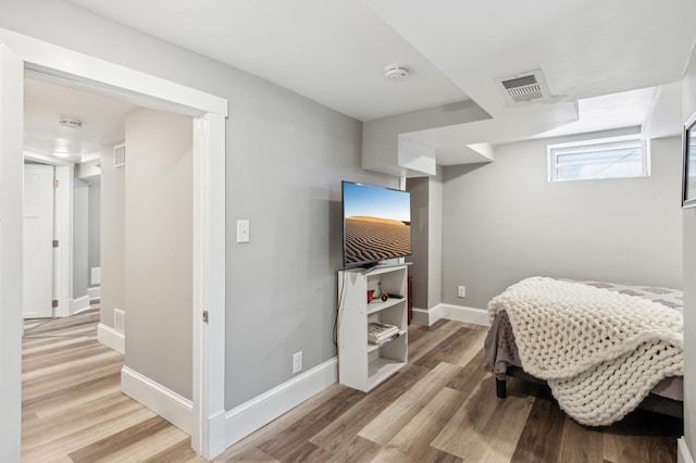 bedroom with visible vents, light wood-style flooring, and baseboards