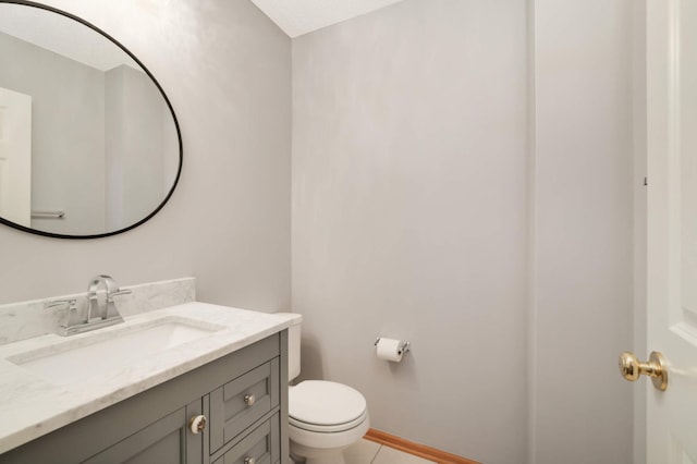 bathroom featuring vanity, toilet, and tile patterned flooring