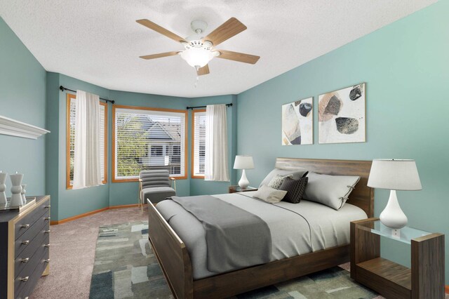 bedroom featuring carpet flooring, baseboards, a textured ceiling, and a ceiling fan
