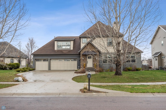 6028 Silverleaf Dr S, Fargo, ND 58104 - view of front of property with driveway, a chimney, a front lawn, an attached garage, and a shingled roof