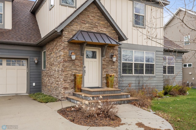 6028 Silverleaf Dr S, Fargo, ND 58104 - view of front of home with board and batten siding, driveway, metal roof, roof with shingles, and stone siding
