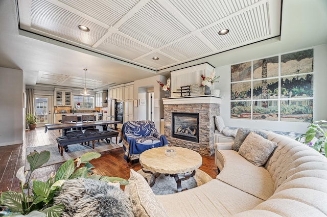 6028 Silverleaf Dr S, Fargo, ND 58104 - living area featuring a stone fireplace, recessed lighting, and hardwood / wood-style flooring