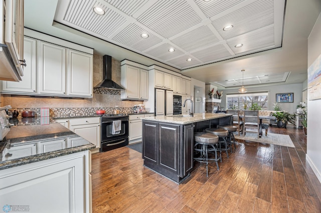 6028 Silverleaf Dr S, Fargo, ND 58104 - kitchen featuring recessed lighting, coffered ceiling, black range with electric stovetop, and wall chimney exhaust hood