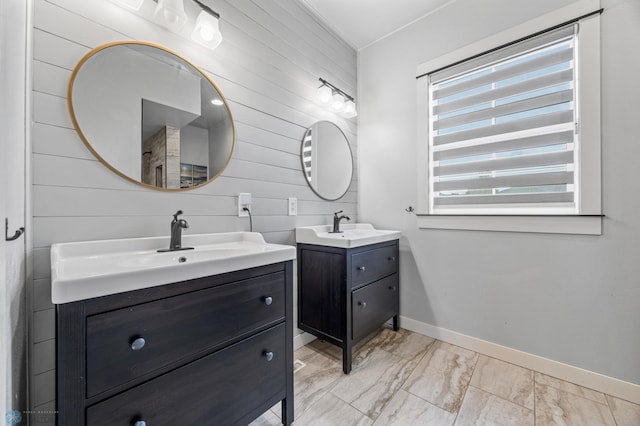 6028 Silverleaf Dr S, Fargo, ND 58104 - full bathroom featuring a sink, wood walls, marble finish floor, baseboards, and two vanities