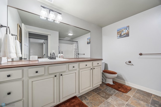 6028 Silverleaf Dr S, Fargo, ND 58104 - full bath with vanity, stone tile floors, curtained shower, toilet, and baseboards