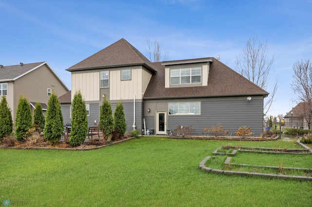 6028 Silverleaf Dr S, Fargo, ND 58104 - rear view of property featuring a lawn, board and batten siding, and roof with shingles