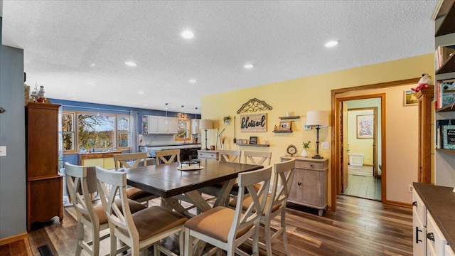 21151 150th St, Sauk Centre, MN 56378 - dining room featuring a textured ceiling, dark wood finished floors, recessed lighting, and baseboards