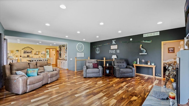 21151 150th St, Sauk Centre, MN 56378 - living room with recessed lighting, wood finished floors, and an accent wall