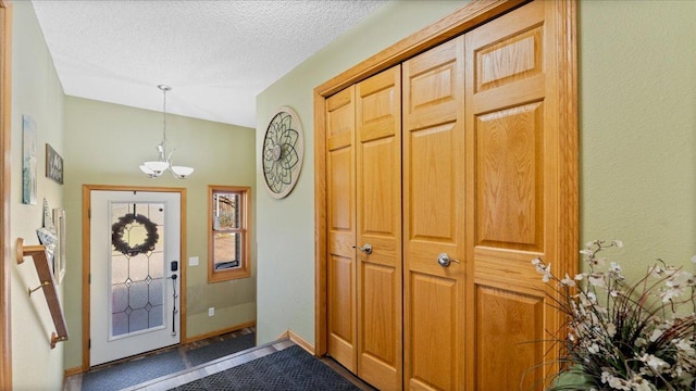 21151 150th St, Sauk Centre, MN 56378 - entrance foyer with a chandelier, a textured ceiling, baseboards, and vaulted ceiling