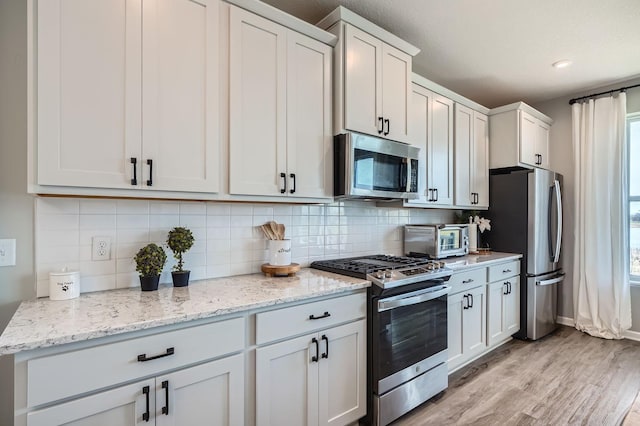 13665 Marsh View Trl, Rogers, MN 55374 - kitchen featuring light wood finished floors, appliances with stainless steel finishes, backsplash, and a toaster