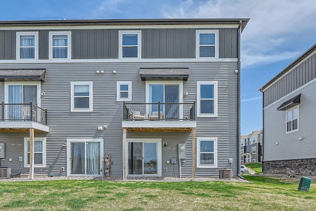13665 Marsh View Trl, Rogers, MN 55374 - rear view of house featuring a lawn, board and batten siding, a balcony, and cooling unit