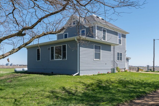 view of side of home with a lawn