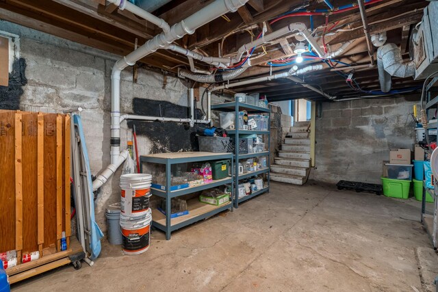 unfinished basement featuring stairway
