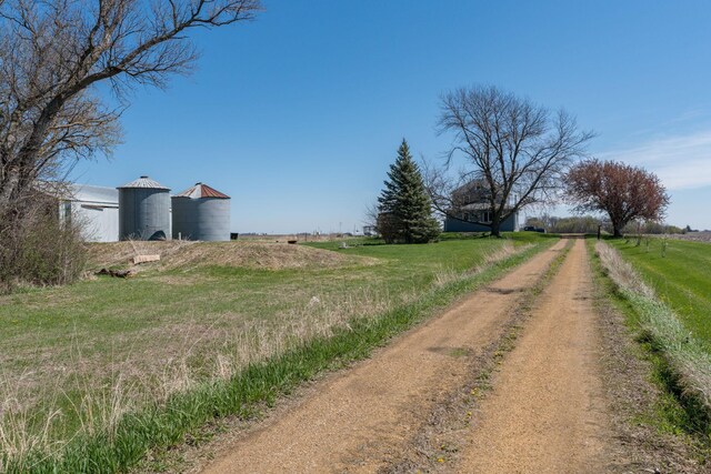 view of road with dirt driveway