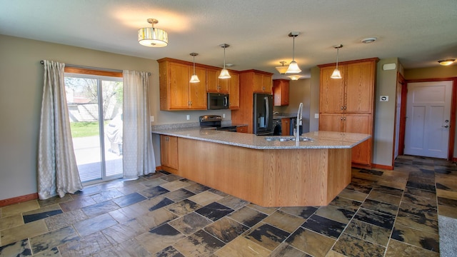 1431 Beech St, Saint Paul, MN 55106 - kitchen with black appliances, a peninsula, baseboards, a sink, and brown cabinets