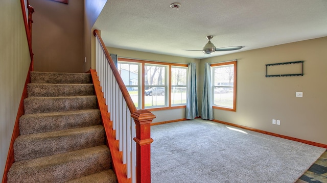 1431 Beech St, Saint Paul, MN 55106 - stairway with a ceiling fan, baseboards, a textured ceiling, and carpet floors