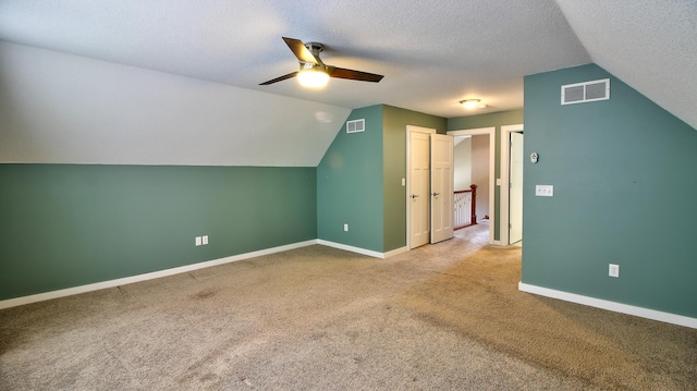 1431 Beech St, Saint Paul, MN 55106 - additional living space with a ceiling fan, vaulted ceiling, carpet, baseboards, and a textured ceiling