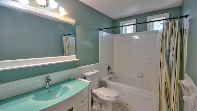 1431 Beech St, Saint Paul, MN 55106 - full bath with shower / bath combo, vanity, toilet, tile walls, and wainscoting