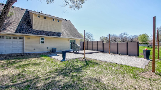 1431 Beech St, Saint Paul, MN 55106 - back of house featuring a patio area, a shingled roof, and cooling unit