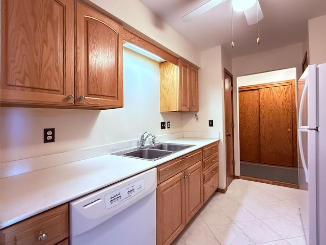kitchen with white appliances, ceiling fan, a sink, and light countertops